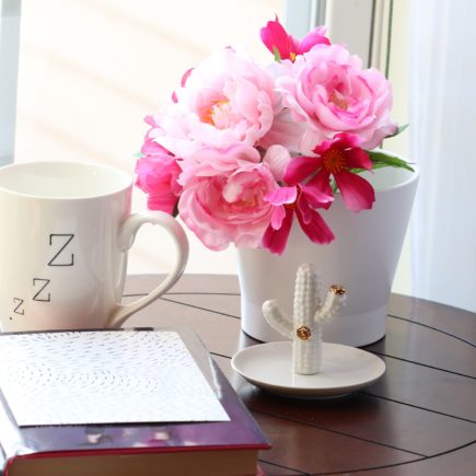 Coffee mug with flowers and notebook on a table - sample